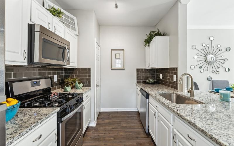 a kitchen with white cabinets
